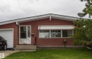 The property features a red exterior with white trim, a single-car garage, and a front lawn - 10512 55 Avenue, Edmonton, AB  - Outdoor 