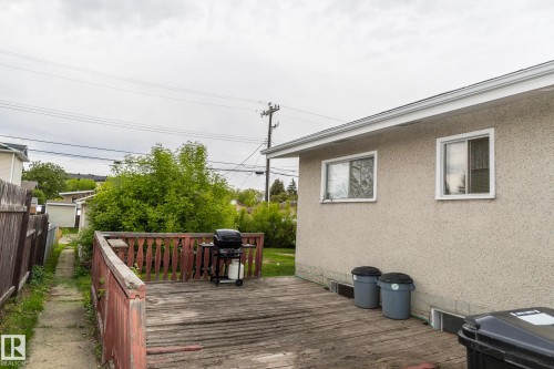 The property features an exterior with stucco siding and a wooden deck - 10512 55 Avenue, Edmonton, AB - Outdoor With Deck Patio Veranda With Exterior