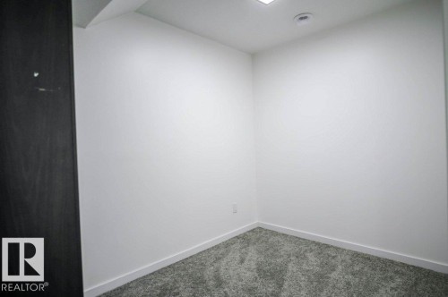 This room features soft gray carpeting, white walls, and a ceiling-mounted light fixture - 266 Charlesworth Drive, Edmonton, AB - Indoor Photo Showing Other Room