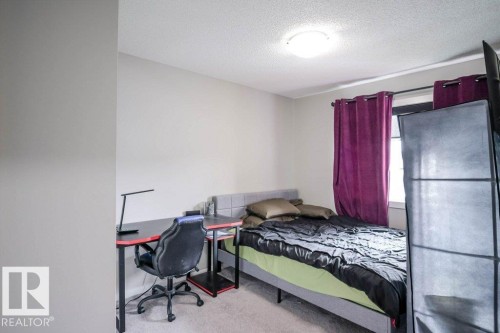 The property features a room with light grey walls, carpeted flooring, and a ceiling light fixture - 266 Charlesworth Drive, Edmonton, AB - Indoor Photo Showing Bedroom