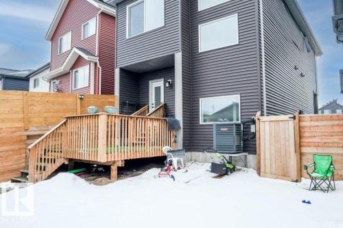 The property features a wooden deck with railing, accessible via a set of stairs - 266 Charlesworth Drive, Edmonton, AB - Outdoor