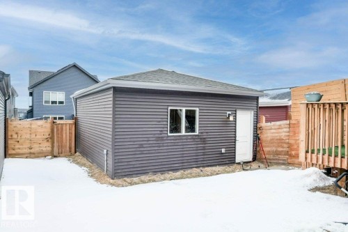 Detached garage with horizontal siding, a window, and an exterior light fixture - 266 Charlesworth Drive, Edmonton, AB - Outdoor