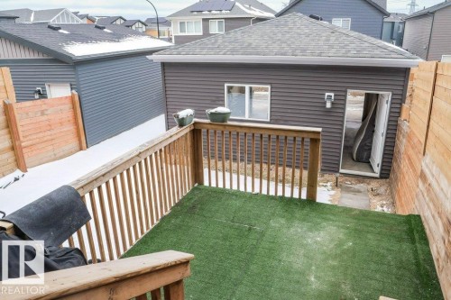 The property features an exterior deck with wooden railings and a green surface - 266 Charlesworth Drive, Edmonton, AB - Outdoor With Exterior
