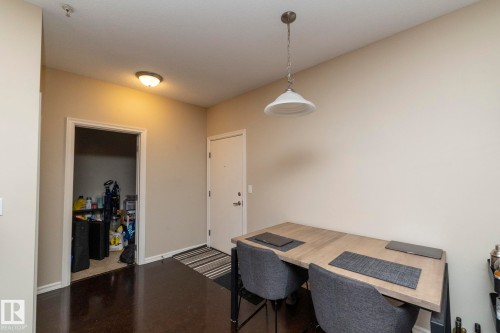 The property offers dark wood flooring, neutral tone walls, and a white ceiling - 416 263 Macewan Road, Edmonton, AB - Indoor Photo Showing Other Room