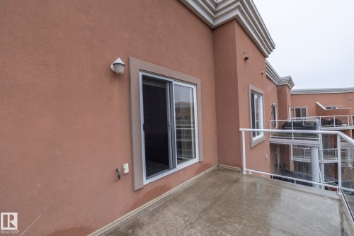 The property features a private balcony with glass railings, providing an outdoor extension to the living space - 416 263 Macewan Road, Edmonton, AB - Outdoor With Balcony With Exterior