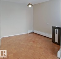 Unfurnished dining area featuring baseboard heating and parquet flooring - 