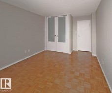 Unfurnished bedroom with parquet floors and a closet - 