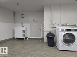 Laundry room with washer / clothes dryer and wood finished floors - 
