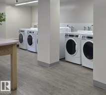Shared laundry room featuring washer and clothes dryer - 