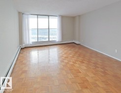 Unfurnished room featuring baseboard heating, parquet flooring, and a textured ceiling - 