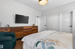 The room features white walls, a light-colored ceiling, and contemporary white doors with dark hardware - 