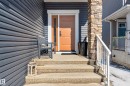 The property features a welcoming entrance with concrete steps and a white handrail, leading to a vibrant orange door - 45 Evermore Crescent, St. Albert, AB  - Outdoor With Exterior 