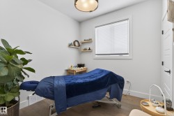 This room features light-colored walls, a window with blinds, and hardwood floors - 