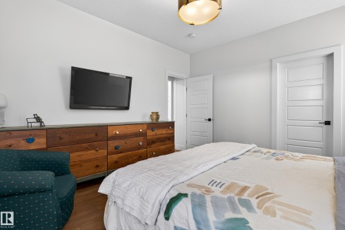 The room features white walls, a light-colored ceiling, and contemporary white doors with dark hardware - 45 Evermore Crescent, St. Albert, AB - Indoor Photo Showing Bedroom