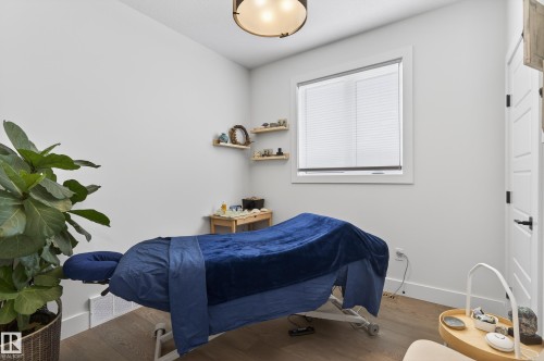This room features light-colored walls, a window with blinds, and hardwood floors - 45 Evermore Crescent, St. Albert, AB - Indoor Photo Showing Bedroom