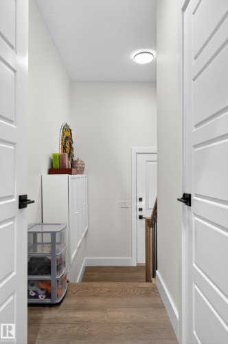 The property features hardwood flooring and white paneled interior doors with black hardware - 45 Evermore Crescent, St. Albert, AB - Indoor Photo Showing Other Room