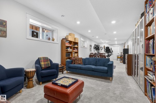 This versatile space features light gray carpeting, recessed lighting, and a white window with a view of an exterior wall - 45 Evermore Crescent, St. Albert, AB - Indoor Photo Showing Living Room