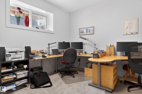 Well-lit room with light-colored walls and grey carpet, featuring a window and two wall-mounted art pieces - 45 Evermore Crescent, St. Albert, AB - Indoor Photo Showing Office
