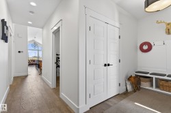 The property features modern hardwood flooring, white walls, and recessed lighting - 