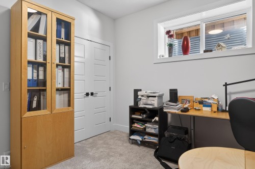 This versatile room features light-colored carpet, a horizontal window, and white walls, offering a bright and functional space - 45 Evermore Crescent, St. Albert, AB - Indoor Photo Showing Office
