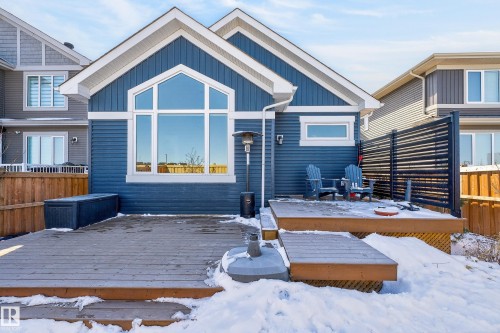 The property features a blue exterior with white trim, a multi-level wooden deck, and a large arched window - 45 Evermore Crescent, St. Albert, AB - Outdoor
