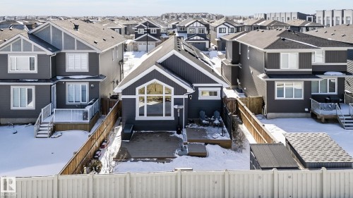 The property features a dark-toned exterior with white trim, a gabled roof, and a prominent arched window on the rear facade - 45 Evermore Crescent, St. Albert, AB - Outdoor With Facade