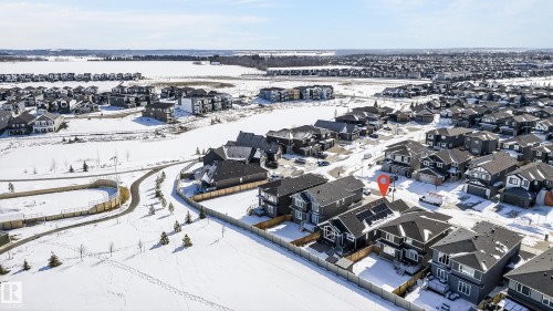 Aerial view of the property and its surrounding neighborhood, featuring residential homes, paved roads, and a clear sky - 45 Evermore Crescent, St. Albert, AB - Outdoor With View
