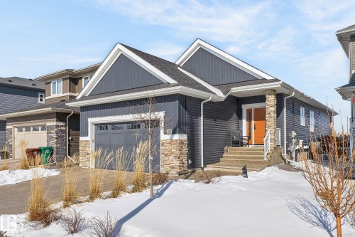 The property features a dark gray exterior with stone accents, a single-car garage, and a light orange front door - 45 Evermore Crescent, St. Albert, AB - Outdoor With Facade