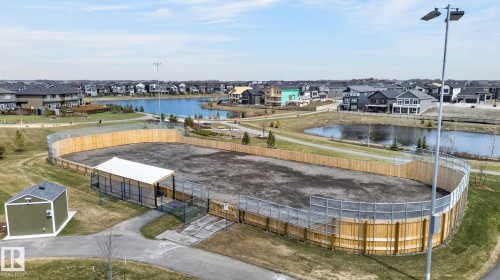 Outdoor recreational area featuring a perimeter fence, covered shelter, and storage building - 45 Evermore Crescent, St. Albert, AB - Outdoor With Body Of Water With View