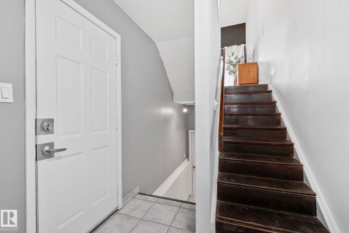 Entryway featuring a white paneled door, light gray walls, and tile flooring - 17082 67 Avenue Nw, Edmonton, AB - Indoor Photo Showing Other Room