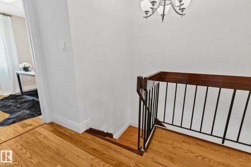 The property features hardwood flooring and a chandelier - 17082 67 Avenue Nw, Edmonton, AB - Indoor Photo Showing Other Room