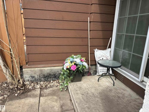 The property features brown horizontal siding and a sliding glass door - 17082 67 Avenue Nw, Edmonton, AB - Outdoor With Exterior