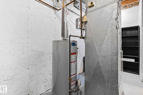 The property features a water heater and ductwork, with unfinished walls and exposed ceiling joists - 17082 67 Avenue Nw, Edmonton, AB - 