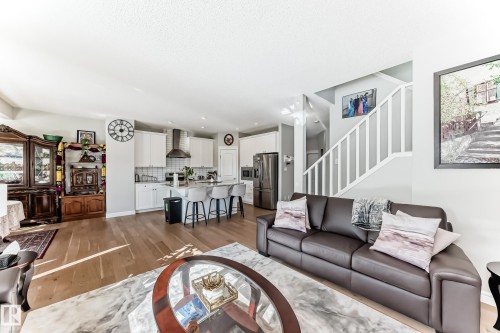 The open concept living area features light wood flooring and light-colored walls, providing an expansive feel - 22407 99 Avenue, Edmonton, AB - Indoor Photo Showing Living Room