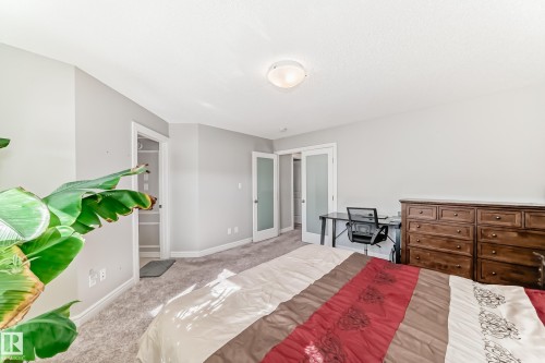 The property features a carpeted room with light gray walls and a ceiling light fixture - 22407 99 Avenue, Edmonton, AB - Indoor Photo Showing Bedroom