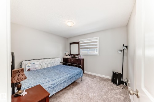 This room features light-colored walls and soft carpet flooring, creating a neutral base - 22407 99 Avenue, Edmonton, AB - Indoor Photo Showing Bedroom