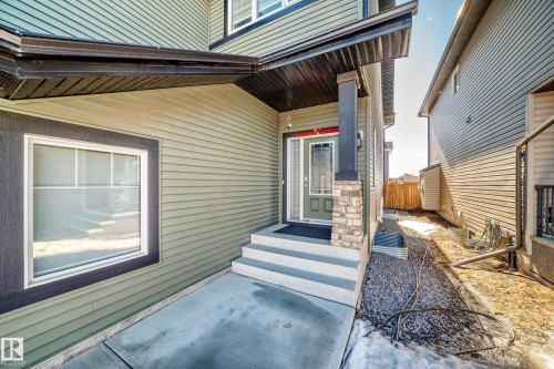 The property features a welcoming entrance with steps leading to the front door, a column accented with stone detailing, and a prominent window - 22407 99 Avenue, Edmonton, AB - Outdoor With Exterior