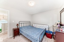The property features a room with light-colored carpeting and walls - 