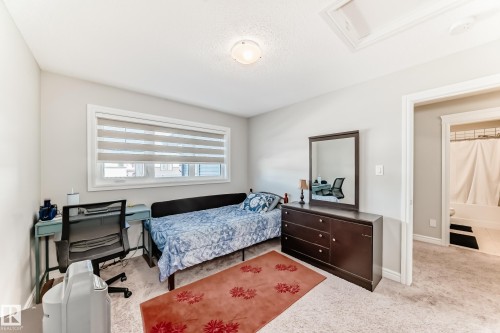 This room features a window with horizontal blinds, light-colored walls, and carpeting - 22407 99 Avenue, Edmonton, AB - Indoor Photo Showing Bedroom
