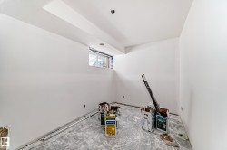 The property features an unfinished interior space with white walls, a window, and a recessed light fixture in the ceiling - 