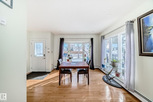 This welcoming space features hardwood flooring and large windows, providing abundant natural light - 16232 100 Street, Edmonton, AB - Indoor