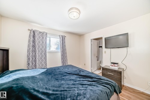 The room features light-colored walls and a window with patterned curtains - 16232 100 Street, Edmonton, AB - Indoor Photo Showing Bedroom