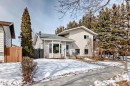 The property features a light-colored exterior, a grey shingled roof, and a bay window - 16232 100 Street, Edmonton, AB  - Outdoor 