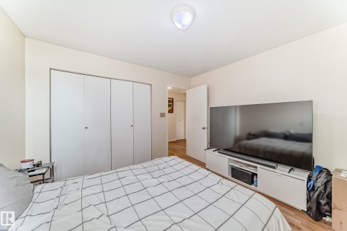 This room features light-colored walls and hardwood flooring - 16232 100 Street, Edmonton, AB - Indoor Photo Showing Bedroom