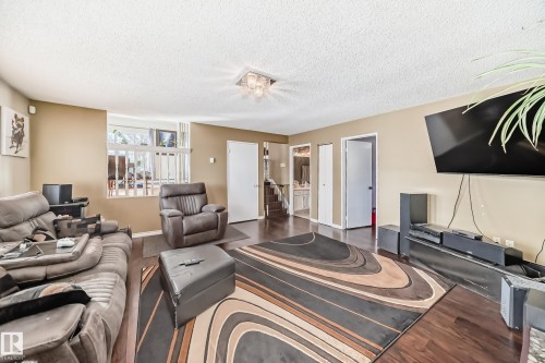 Living area featuring hardwood flooring, a window, and light-colored walls - 16232 100 Street, Edmonton, AB - Indoor