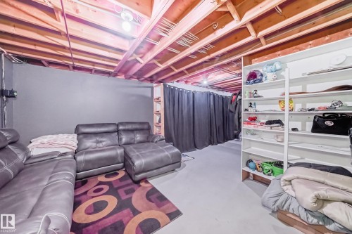The property features an unfinished basement with exposed ceiling joists, painted gray walls, and a light gray floor - 16232 100 Street, Edmonton, AB - Indoor Photo Showing Basement