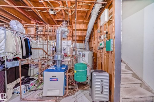 Utility area featuring exposed copper piping, a water heater, and a furnace unit - 16232 100 Street, Edmonton, AB - Indoor Photo Showing Basement