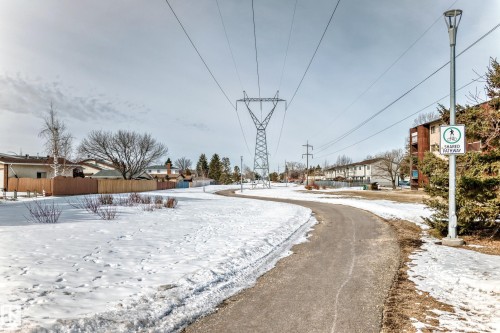 The property features a paved pathway and a shared pathway sign, indicating convenient outdoor recreation options - 16232 100 Street, Edmonton, AB - Outdoor