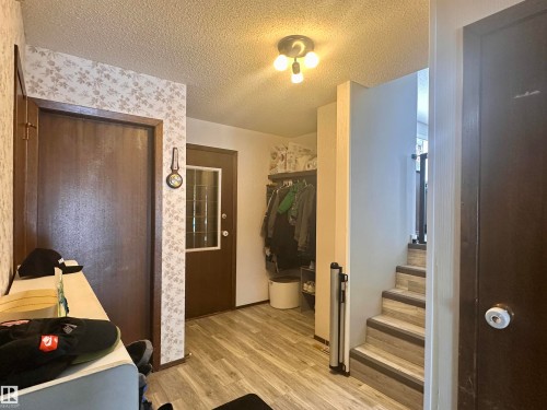 Entryway featuring durable flooring and a staircase with textured risers - 9915 95 Street, Westlock, AB - Indoor Photo Showing Other Room