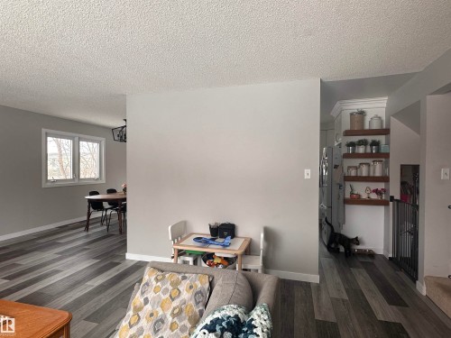 This interior view features grey-toned flooring and light grey walls - 9915 95 Street, Westlock, AB - Indoor